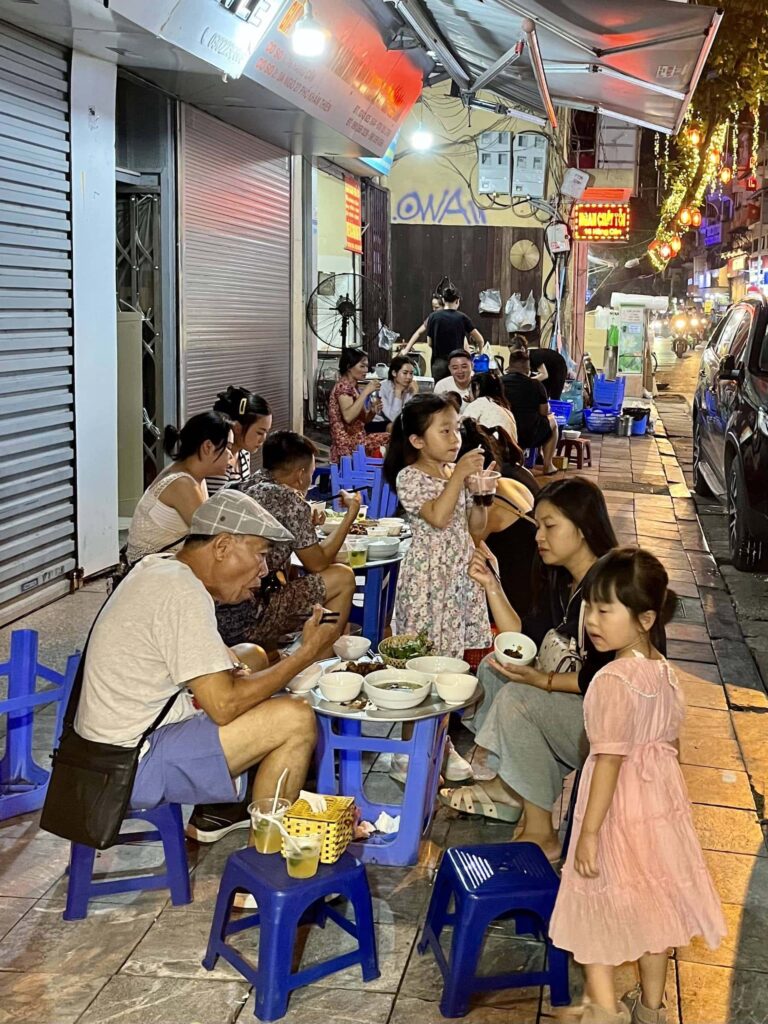 Street food is typically served on small plastic tables and stools in Hanoi's Old Quarter.