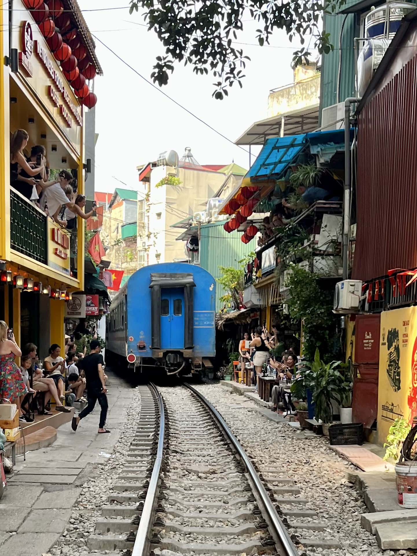 If you're at the Train Street in Hanoi's Old Quarter at the right time, you can observe how the alley is quickly cleared for the passing train.