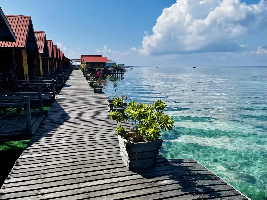 Visiting Semporna: What to Know Before You Dive or Transit 7 A resort on Mabul Island in Semporna featuring water bungalows built above turquoise waters