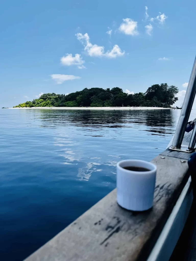 Diving Sipadan: A Complete Guide to Malaysia’s Top Dive Destination 9 A coffee cup on the speedboat with a view of Sipadan Island.