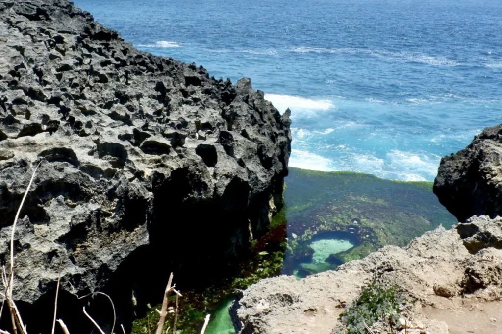 Natural tide pool surrounded by volcanic rock formations at Angel’s Billabong, a unique coastal feature on Nusa Penida.